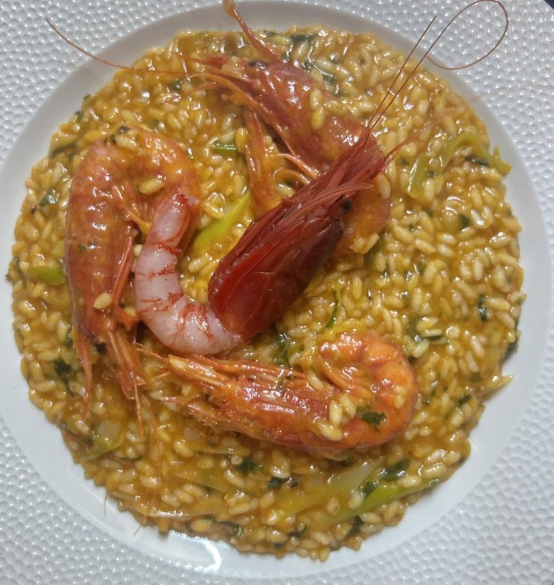 Creamy risotto topped with red prawns